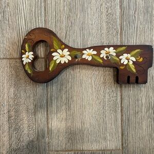 Hand-Painted Brown Decorative Key Wall Accent with White Daisy Motif